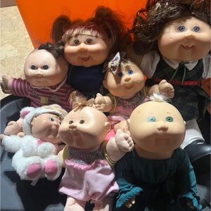 Cabbage Patch dolls a lot of 7 dolls and throwing in a couple extras